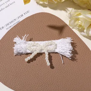Handmade faux pearl fabric bow accessory, white fringe design, perfect for DIY crafts.