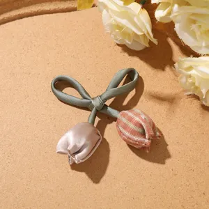 Detailed shot of sweet forest style double tulip bow hair accessory with grid fabric.