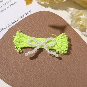 Green frayed fabric bow hairpin with imitation pearls, DIY handmade clothing accessories.