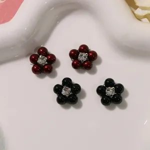 Detailed close-up of retro baroque five-petal pearl rhinestone DIY nail art flower accessories.