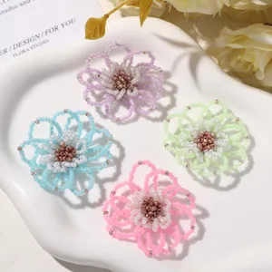 Close-up detail of fresh beaded hollow flower DIY accessories in four vibrant colors on tray.