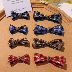Close-up detail of plaid bow hair clips with metal cross charm, perfect for JK style outfits.