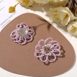 Close-up detail of forest style frosted beaded hollow flower DIY accessories and brooch.
