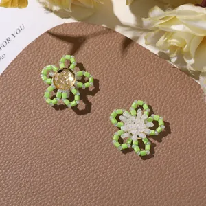 Detailed close-up of cute handmade green tube beaded flower accessories, perfect for DIY jewelry.
