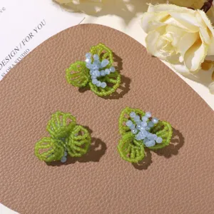 Detailed close-up of handmade beaded three-petal flower DIY jewelry accessories and crafts.