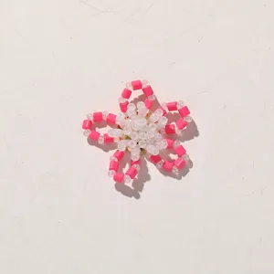 Detail view of handmade pink and clear beaded flower DIY accessory, perfect for custom decoration.