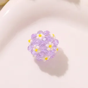 Close-up detail of purple beaded daisy flower ball, handmade diy accessory for earrings.