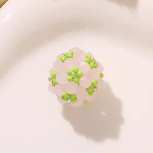 Handcrafted pink and green beaded flower ball DIY charm for earrings and hair accessories.