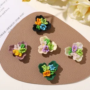 Detailed view of handmade beaded three-petal flower DIY charms for earrings and crafts.