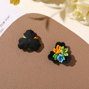 Close-up of DIY colorful beaded three-petal flower accessories, forest style detail view.