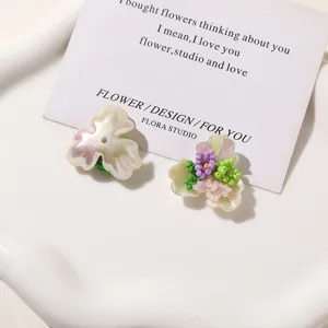 Detailed close-up of pearl textured three petal flower seed bead DIY jewelry charm.