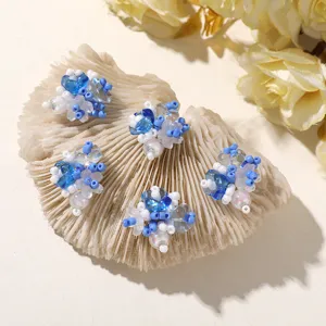 Close-up detail of blue and white beaded flower charms, perfect for DIY jewelry and hair accessories.