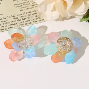 Close-up detail of colorful translucent resin flower DIY accessories with beaded center.