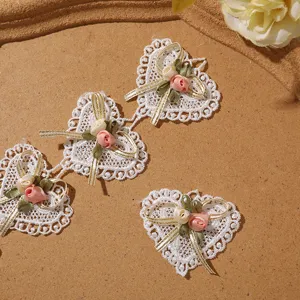 White heart lace patch with 3d bow and rose detail, delicate diy garment accessory.