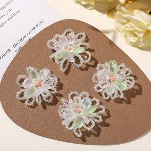 Detailed view of handmade glass beaded flower DIY charms, transparent iridescent petals for earrings.