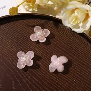 Pink resin four-petal flower charms with crystal center, perfect for DIY jewelry and shoes.