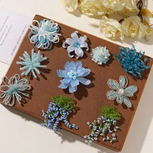 Close-up detail of handmade blue beaded flower charms and appliques for DIY crafts.
