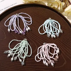 Detailed view of handmade crystal beaded tassel accessories with delicate pearls and floral rhinestone.