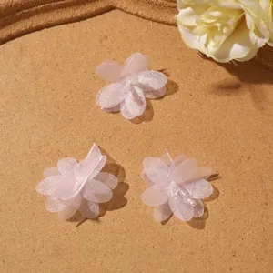 Primo piano di fiori in tessuto rosa chiaro accessori DIY dettaglio per decorazioni.