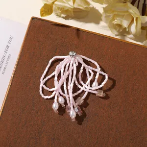 Exquisite pink beaded crystal tassel detail shot showcasing delicate craftsmanship and sparkling rhinestones.