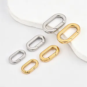 Close up of polished oval spring clasps in silver and gold, perfect for DIY jewelry making.