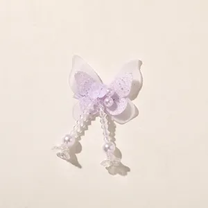 Detailed shot of a sparkly purple butterfly hair clip patch with beaded tassel accents.