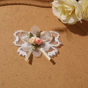 Detailed view of white mesh lace butterfly bow patch featuring tiny roses for DIY craft decor.