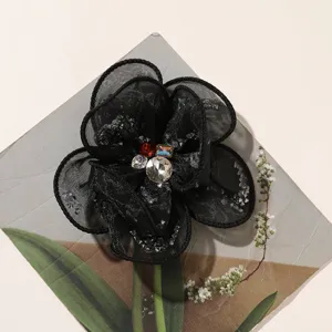 Black mesh rhinestone flower DIY hair accessory patch clothing bag decor detail view.