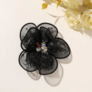 Black mesh fabric flower DIY accessory with sparkling center rhinestones for apparel craft.