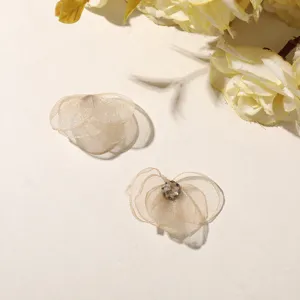 Detailed close-up of delicate mesh flower DIY accessories with sparkling rhinestone, perfect.