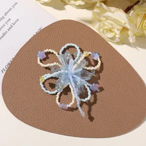 Detailed view of handmade blue and white beaded flower accessory for DIY jewelry making.