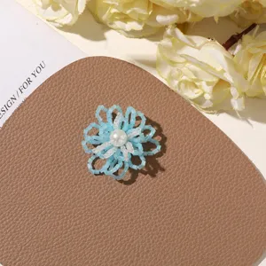 Handmade blue beaded flower DIY accessory, delicate seed bead floral charm for brooch and earrings.