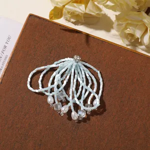 Detailed shot of light blue beaded crystal tassel rhinestone flower DIY jewelry accessory part.