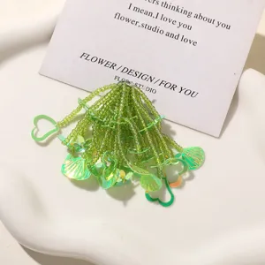 Green beaded flower DIY accessory detail, perfect for summer shoes, hair clips and creative crafts.