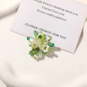 Green beaded flower detail shot, handmade DIY charm accessory for earrings and hair accessories.