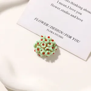 Close-up detail shot of green beaded flower DIY accessory, perfect for custom jewelry making.