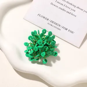 Green beaded flower DIY accessory detail, textured sequin cluster shoe charm and stud decor.