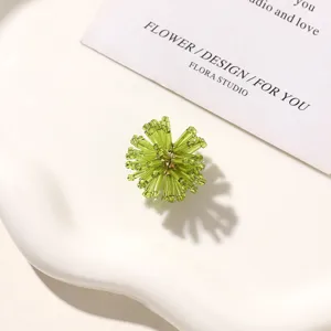 Detailed shot of green beaded flower, fresh DIY accessory for earrings and clogs.