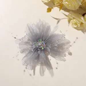 Close-up detail of grey mesh crystal beaded flower DIY accessory, delicate texture.
