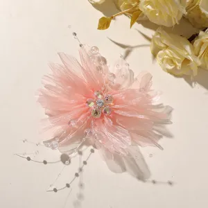 Close-up view of sweet pink mesh flower with crystal bead center and delicate dangling strings.