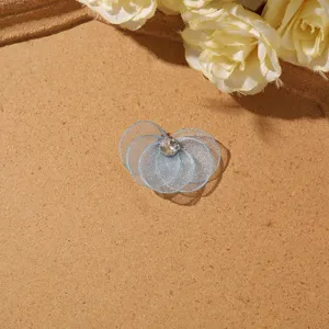 Blue mesh flower DIY accessory close-up, sparkly crystal center for earrings and crafts.
