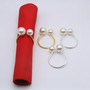 Elegant dual pearl napkin rings in gold and silver, perfect for wedding table decor and dining events.