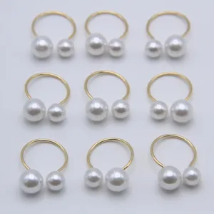 Elegant open ring featuring asymmetric dual pearls on a gold-plated metal band design.