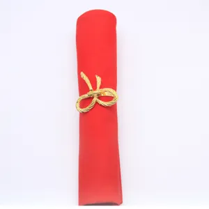 Close-up of the elegant gold bow napkin ring with exquisite metallic finish for stylish table decor.