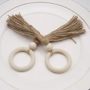 Handmade jute rope napkin ring with wooden beads and ring, rustic table decor detail view.