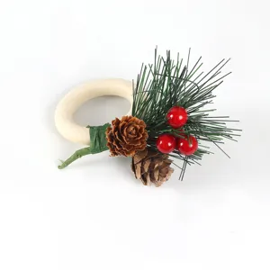 Christmas napkin ring with wooden ring, artificial pine needles, pinecones, and red berries.