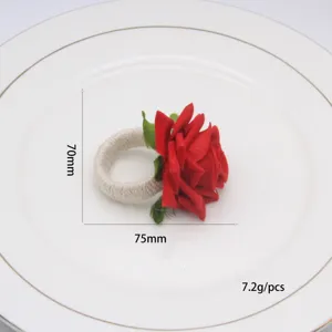 Primo piano dettaglio di portatovagliolo con rosa rossa in tessuto fatto a mano.