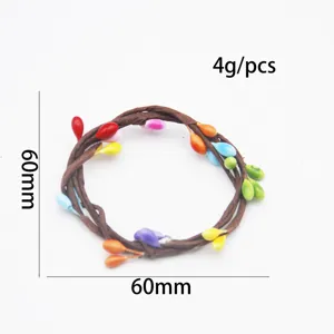 Handmade braided vine napkin ring with colorful berries, detail view showing 60mm size.