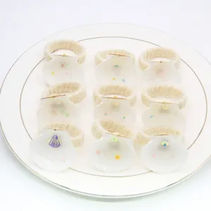Close-up of handmade natural white seashell napkin rings set, elegant table decor for dining.