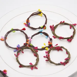 Handmade woven vine napkin rings with colorful berry decorations, perfect for party table decor